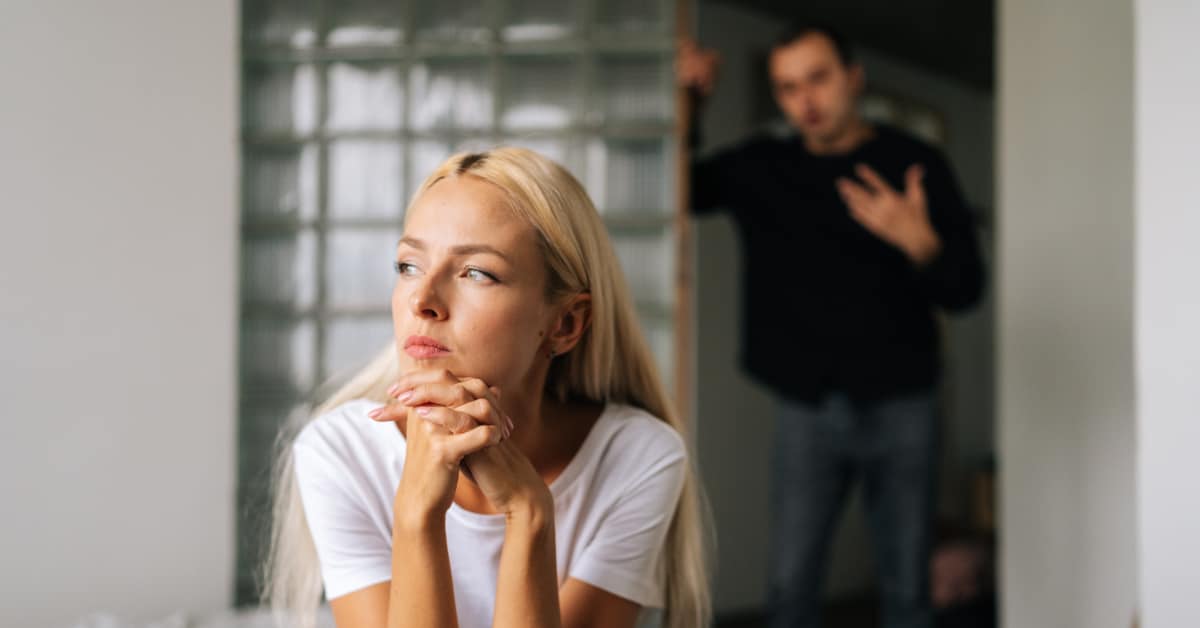 woman thinking with man in background