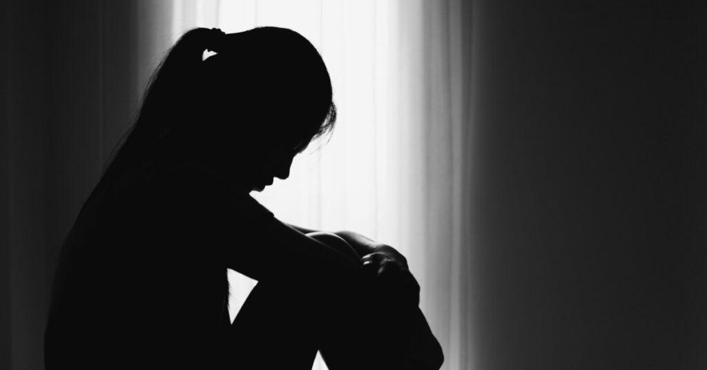 depressed woman sitting on floor fro domestic violence and marital torts