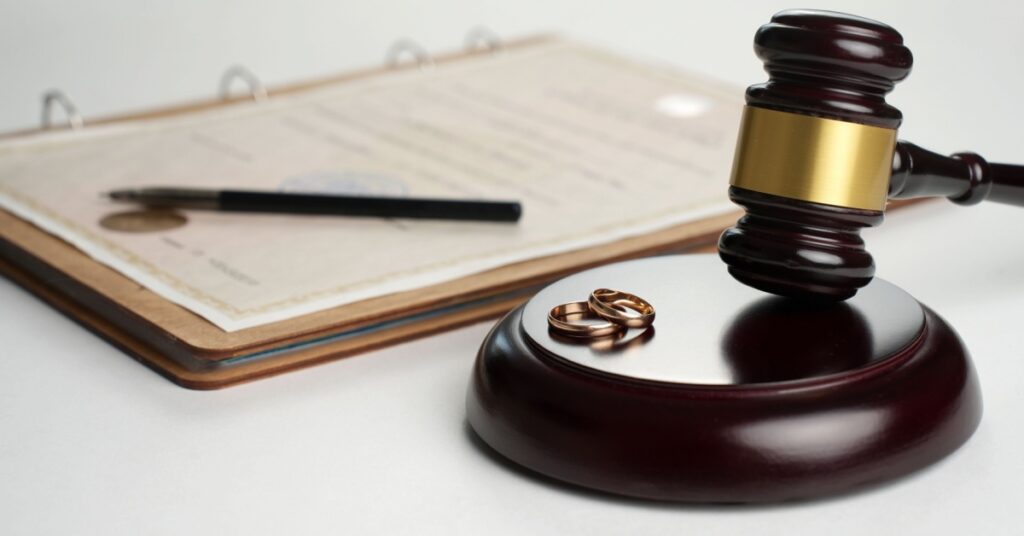 wedding rings, gavel and paper, concept of steps to serve divorce papers in NJ