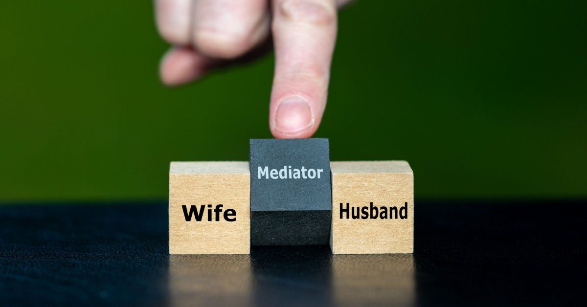 cubes with words mediator, wife, husband, concept of neutrality in divorce mediation