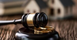 gavel and wedding bands concept of Avoiding Costly Divorce Settlement Mistakes in New Jersey